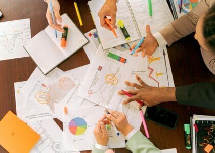 Business professionals collaborating over charts and data in a conference room.